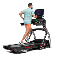 Man using the touchscreen on the Treadmill 56 --thumbnail